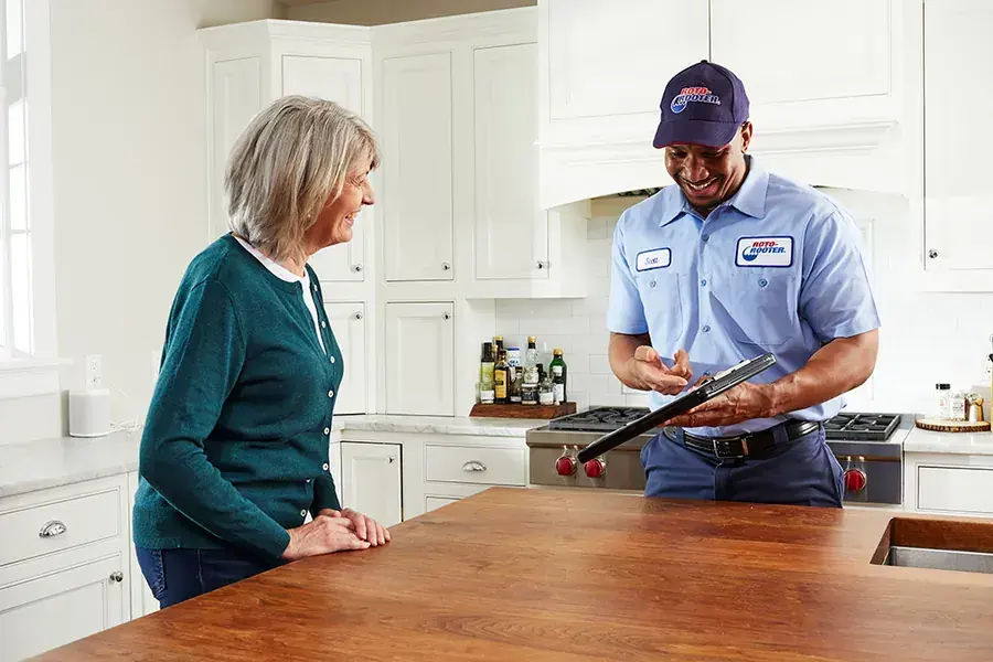 Texas Dry Home technician reviewing a water damage job with a Spicewood homeowner