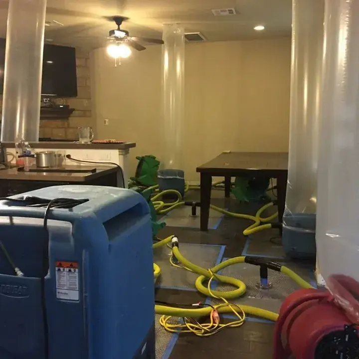 Flood-cut walls drying after a slab leak in a Lake Travis Hill Country home