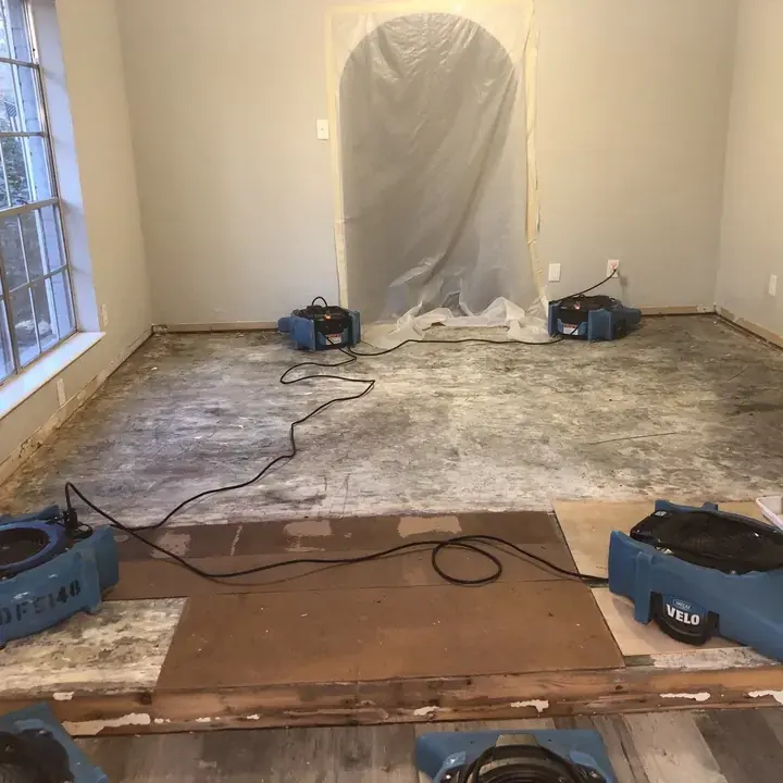Air movers drying a water damaged family room in a Lake Travis Hill Country home