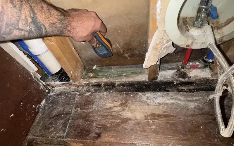 A wall opened to exposed water pipes after a burst pipe in a Spicewood, TX home