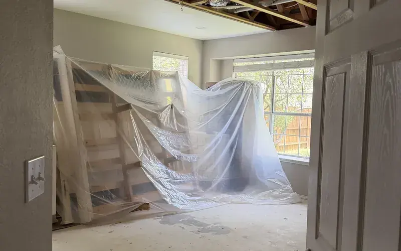 Storm water damage with an opened ceiling drying in a Spicewood, TX room